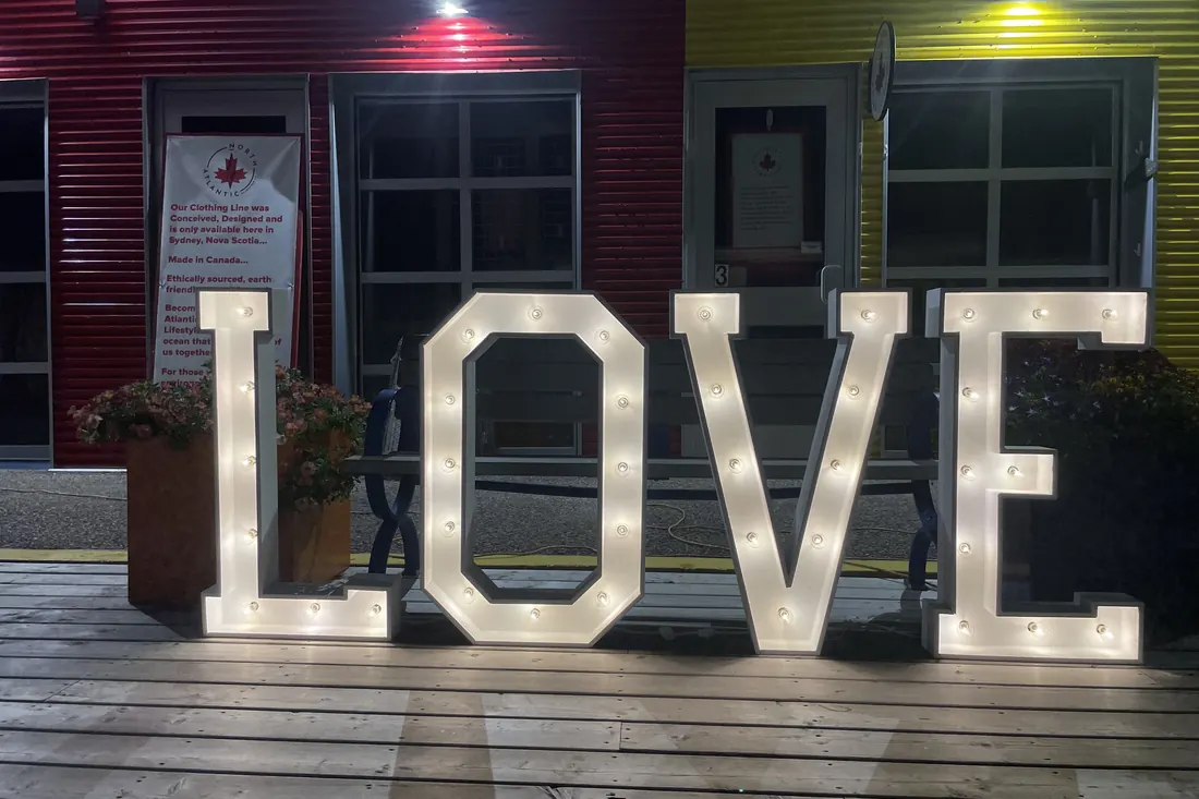 LOVE in lit marquee letters on the boardwalk at the Port of Sydney